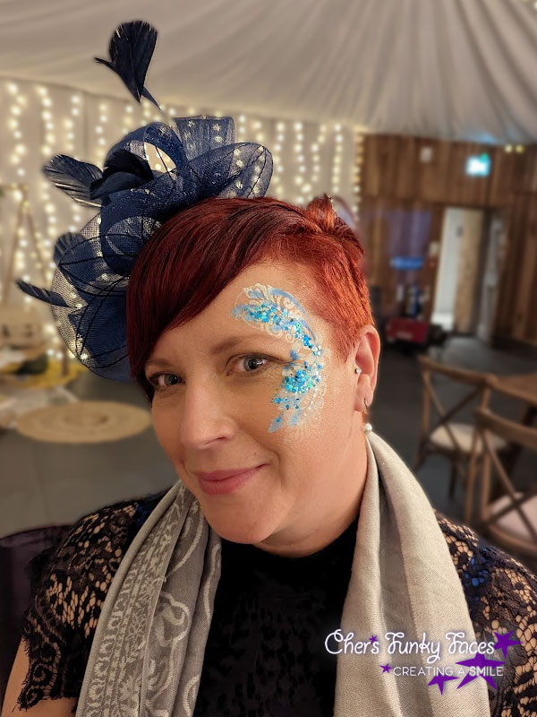 Blue flowery festival face paint and glitter at wedding reception Trevenna Chers Funky Faces