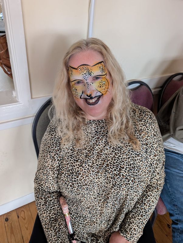 Mum with leopard face paint designed by Cher's Funky Faces at UV glow party Saint Dominic