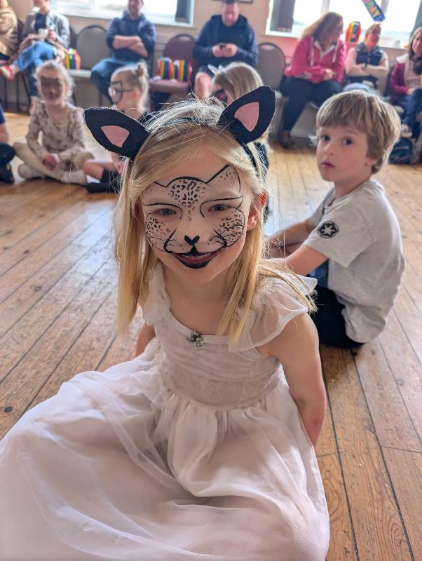 Child with Grey leopard facepaint and cat ears on painted by Cher Funky Punky Chers Funky Faces UV glow party