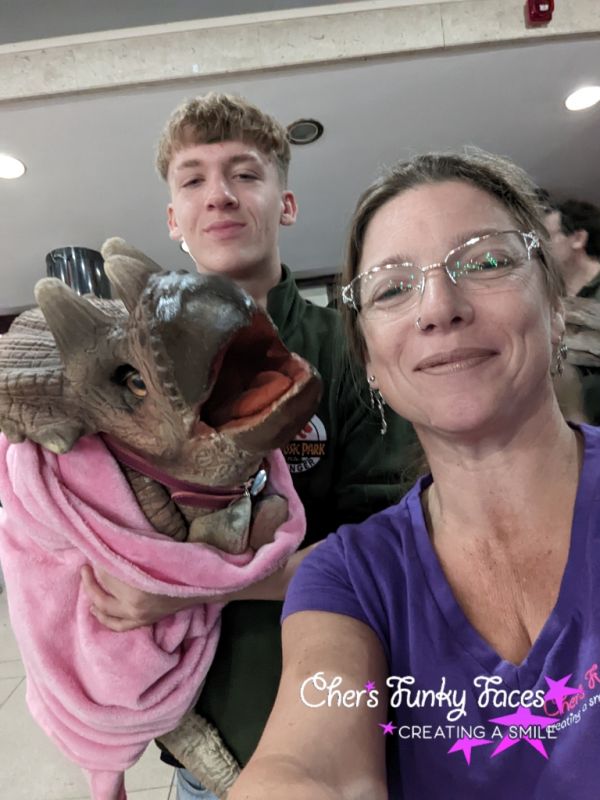 cher with baby dinosaur at Devcon Chers Funky Faces