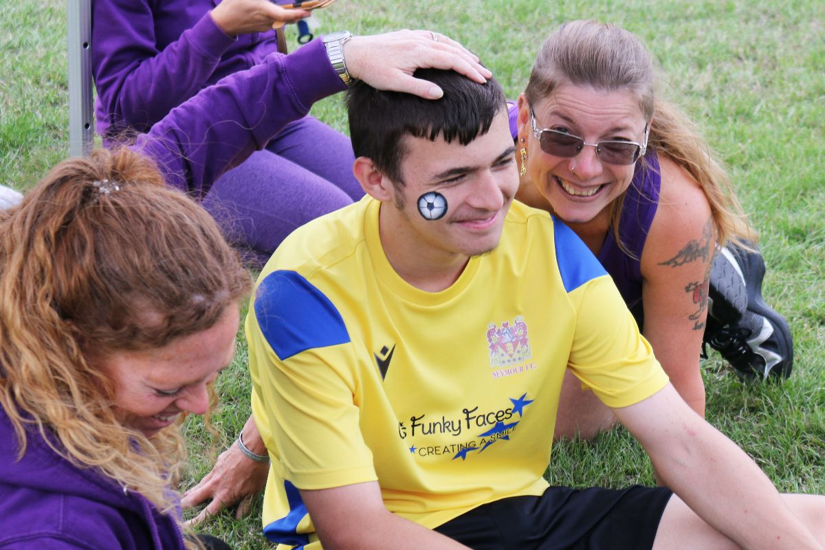 Sophia-painting-football-with-Cher-in-backgroud.jpg