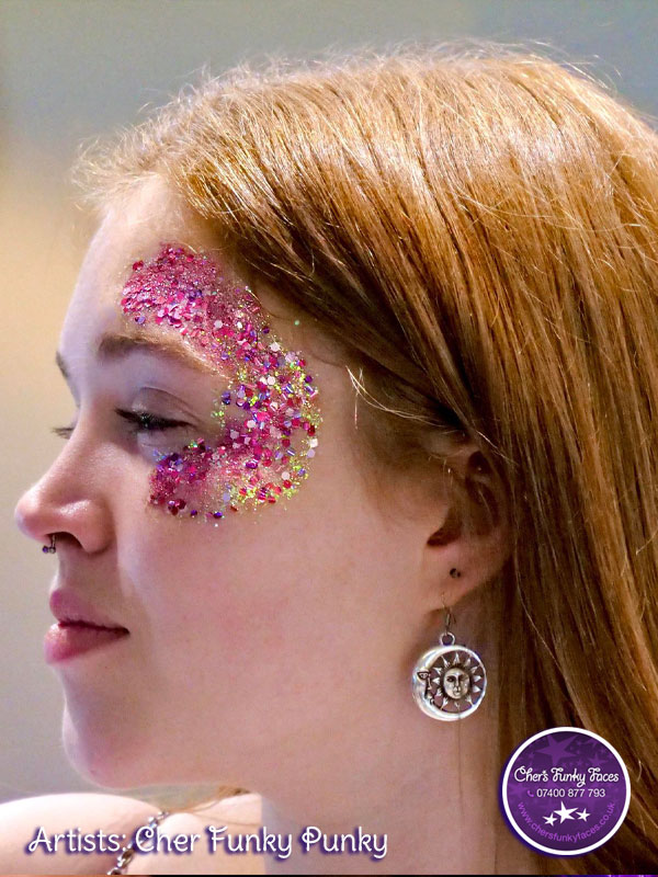 beautiful pinks and golds biodegradable glitter applied round students eye in a half moon shape by chers funky faces