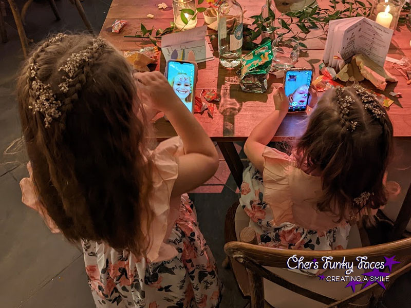Kids playing with their painted faces on snap chat wedding reception Trevenna Chers Funky Faces