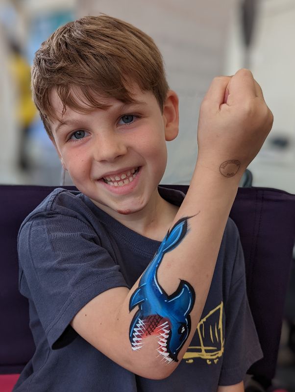 Shark eating elbow face body paint