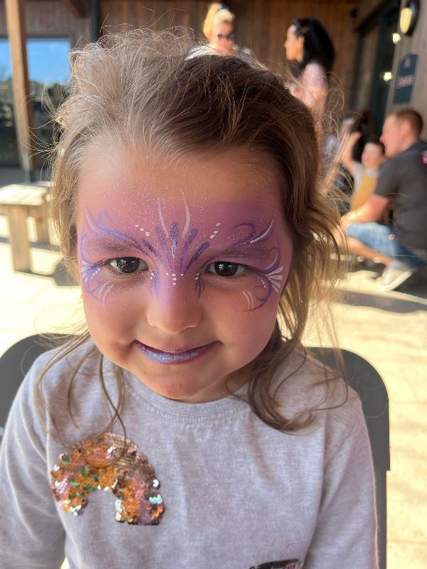 Beautiful princess facepaint in the colours pink/purple and white