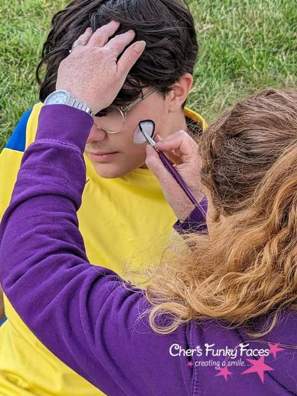 Sophia-painting-Football-on-tem-Player-cheek.jpg