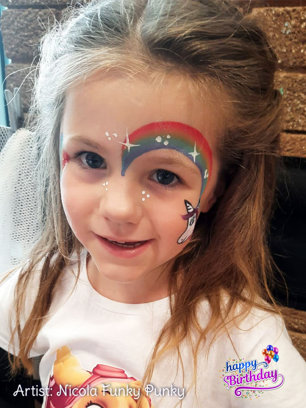 Rainbow with unicorn on cheek face paint by Nicola Funky Punky Chers Funky Faces