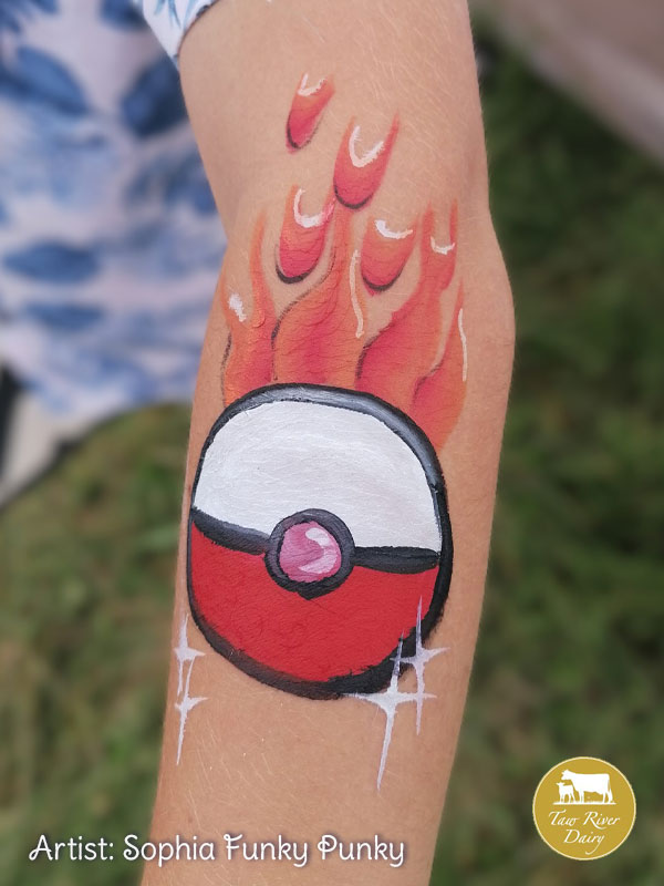 Pokeball with flames painted on arm by Sophia Funky Punky at Taw River Dairy Open Day Cher's Funky Faces
