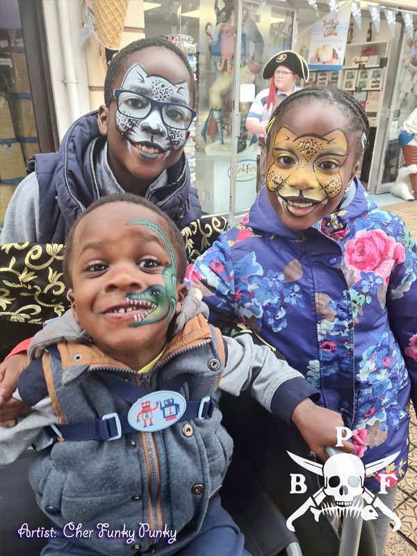 2 cats and 1 dinosaur face paint by Chers funky faces at Brixham pirate festival