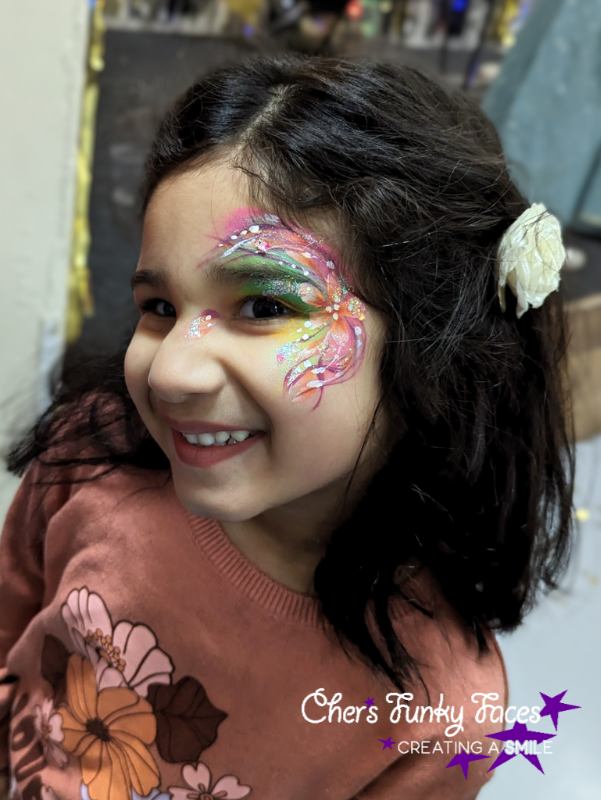 Rainbow flower design face paint by Cher funky punky